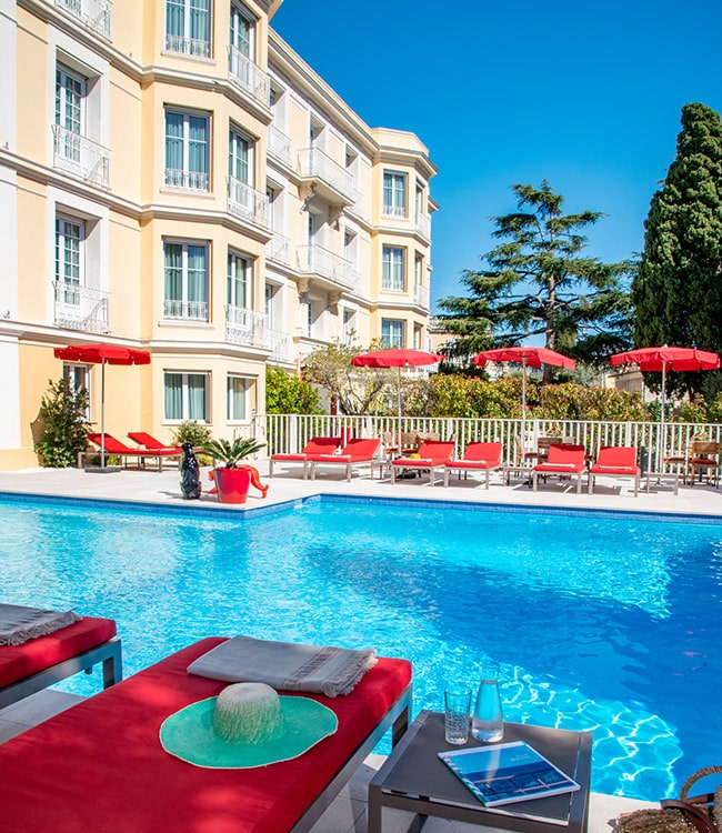 Swimming pool and sun loungers at the Carlton Beaulieu hotel